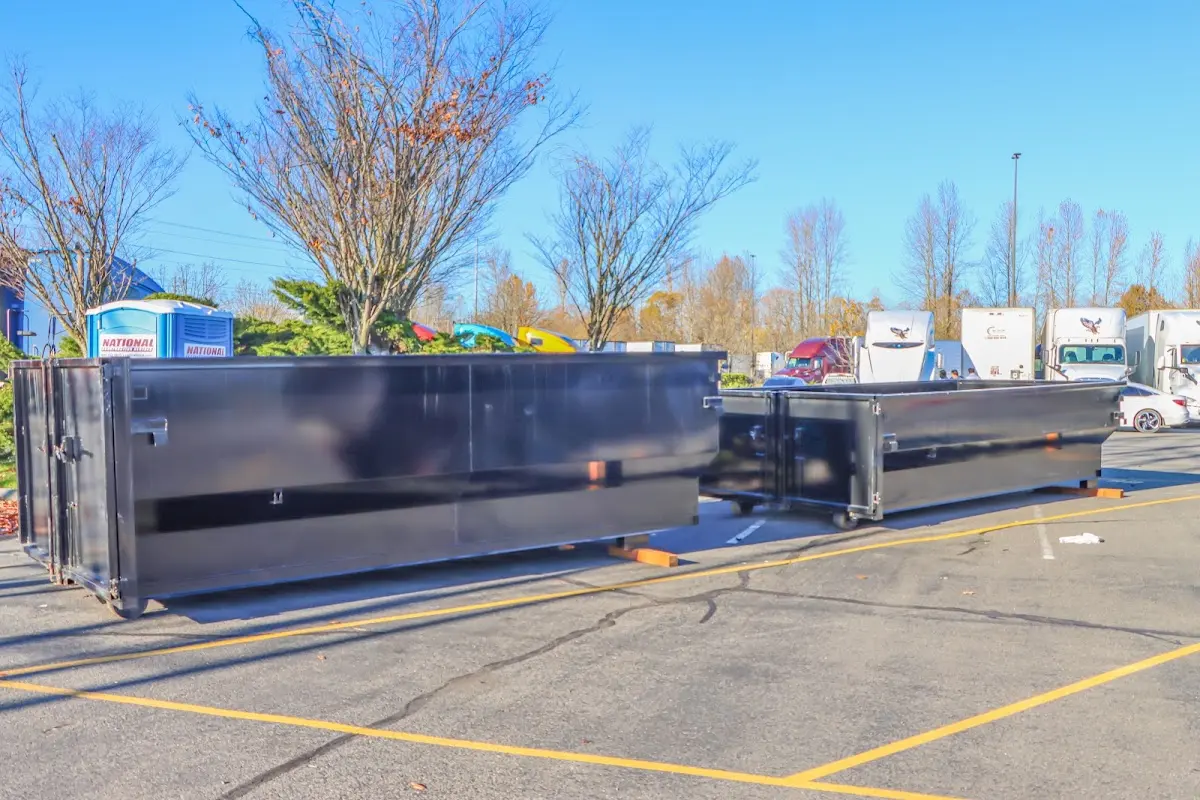 Professional dumpster rental service with roll-off container on residential driveway in Oroville East